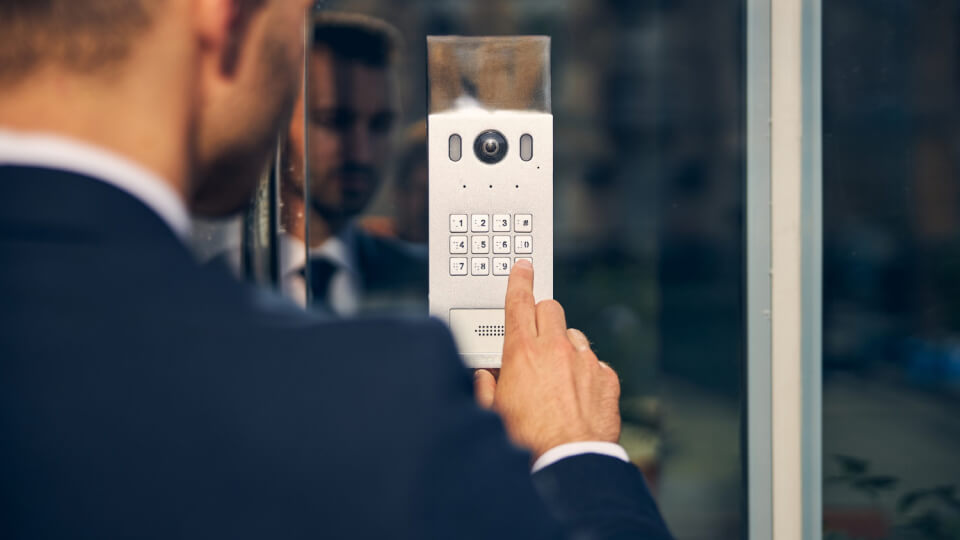 A business man accessing his commercial security systems which secures his local business in Perth 